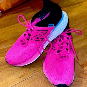 Women’s size 9 pink and black New Balance shoes.